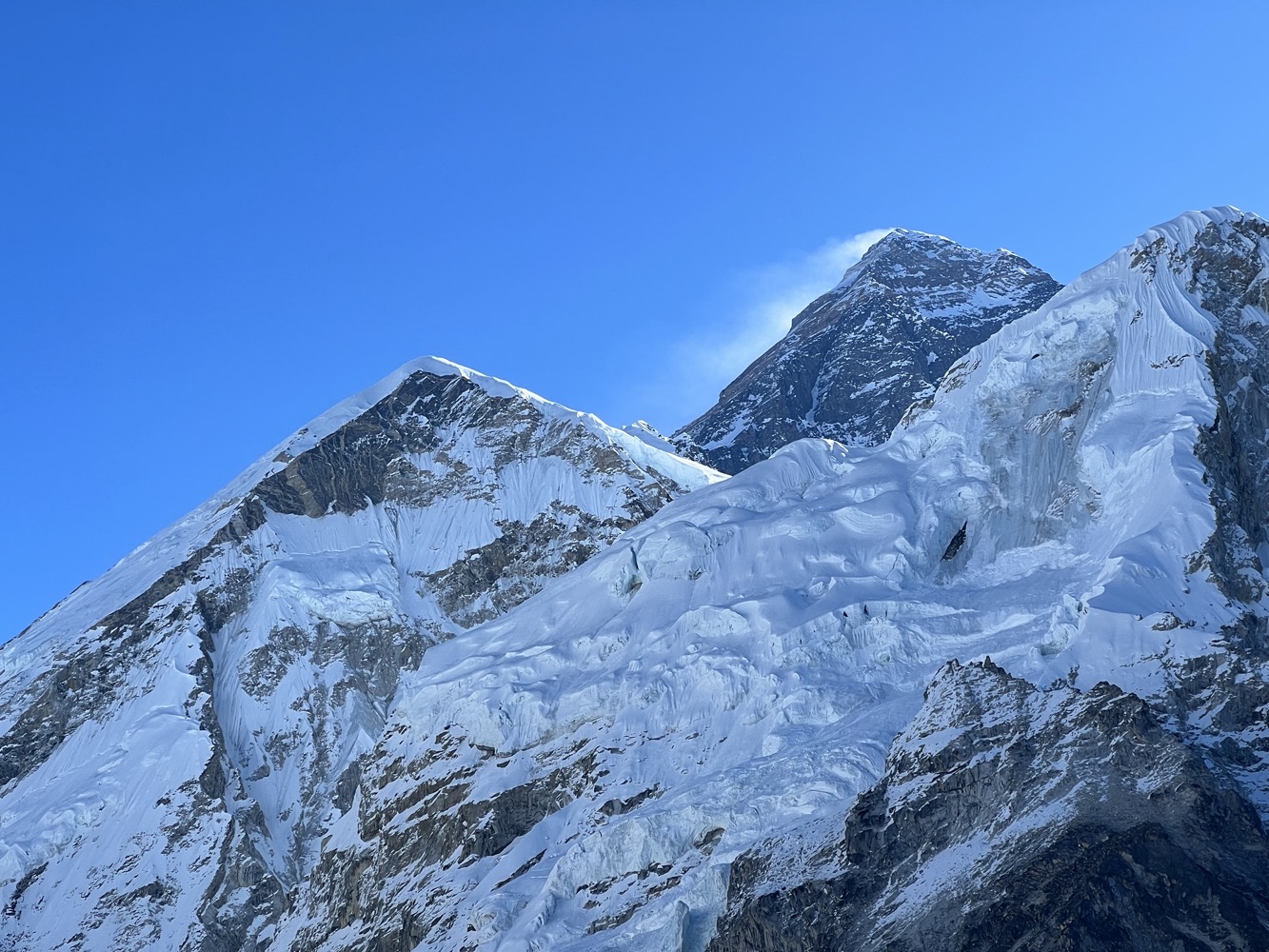 a snowy mountain tops with blue sky