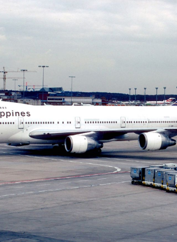 a large white airplane on a runway