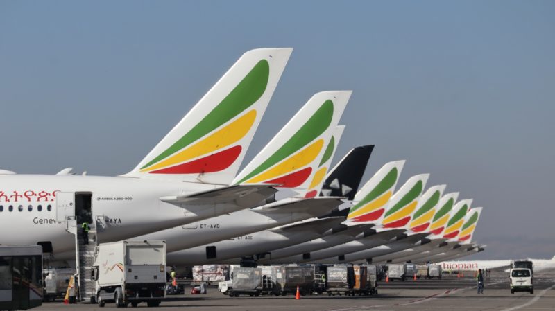 a row of airplanes parked in a line