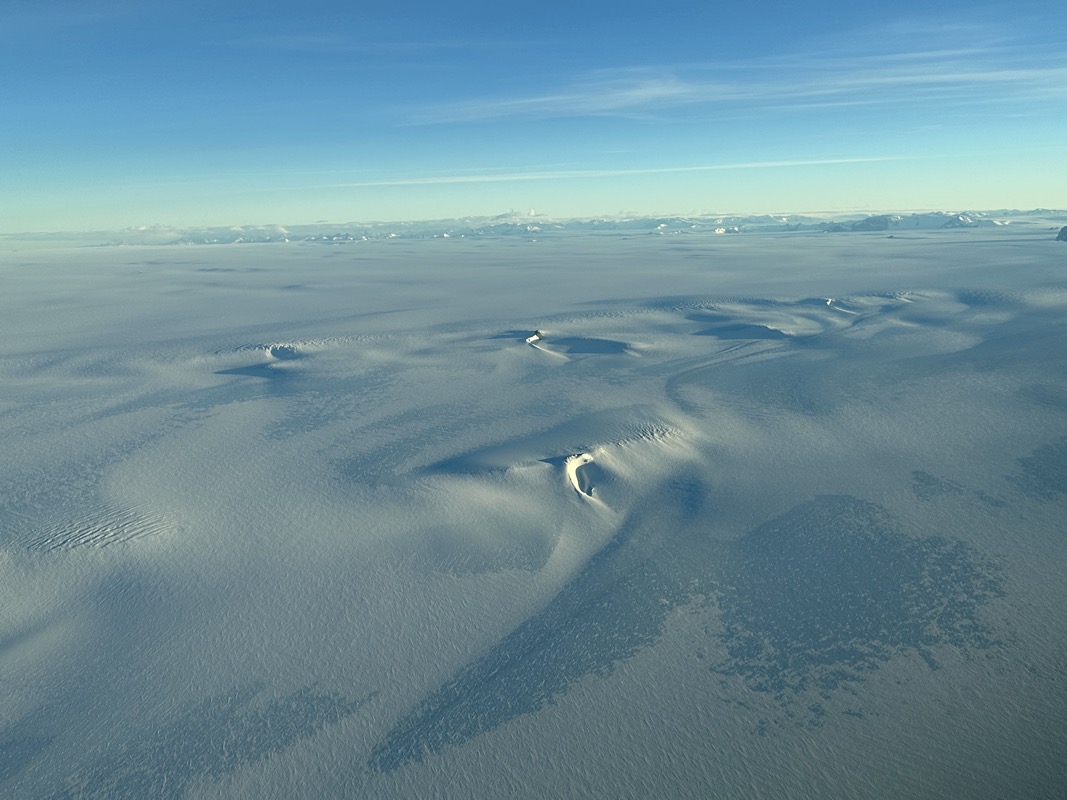 a snow covered ground with blue sky