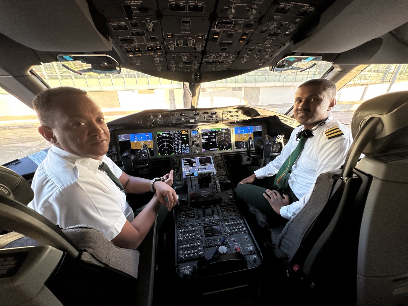 two men in a cockpit of an airplane