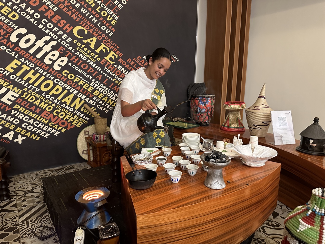 a woman pouring coffee into a cup