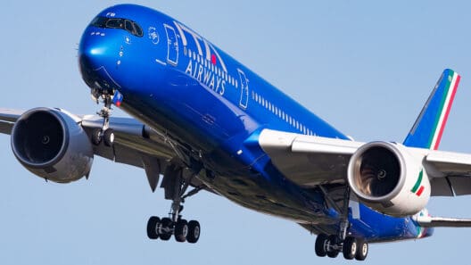 a blue airplane in the sky