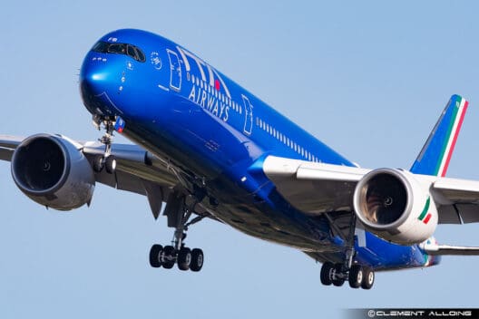 a blue airplane in the sky