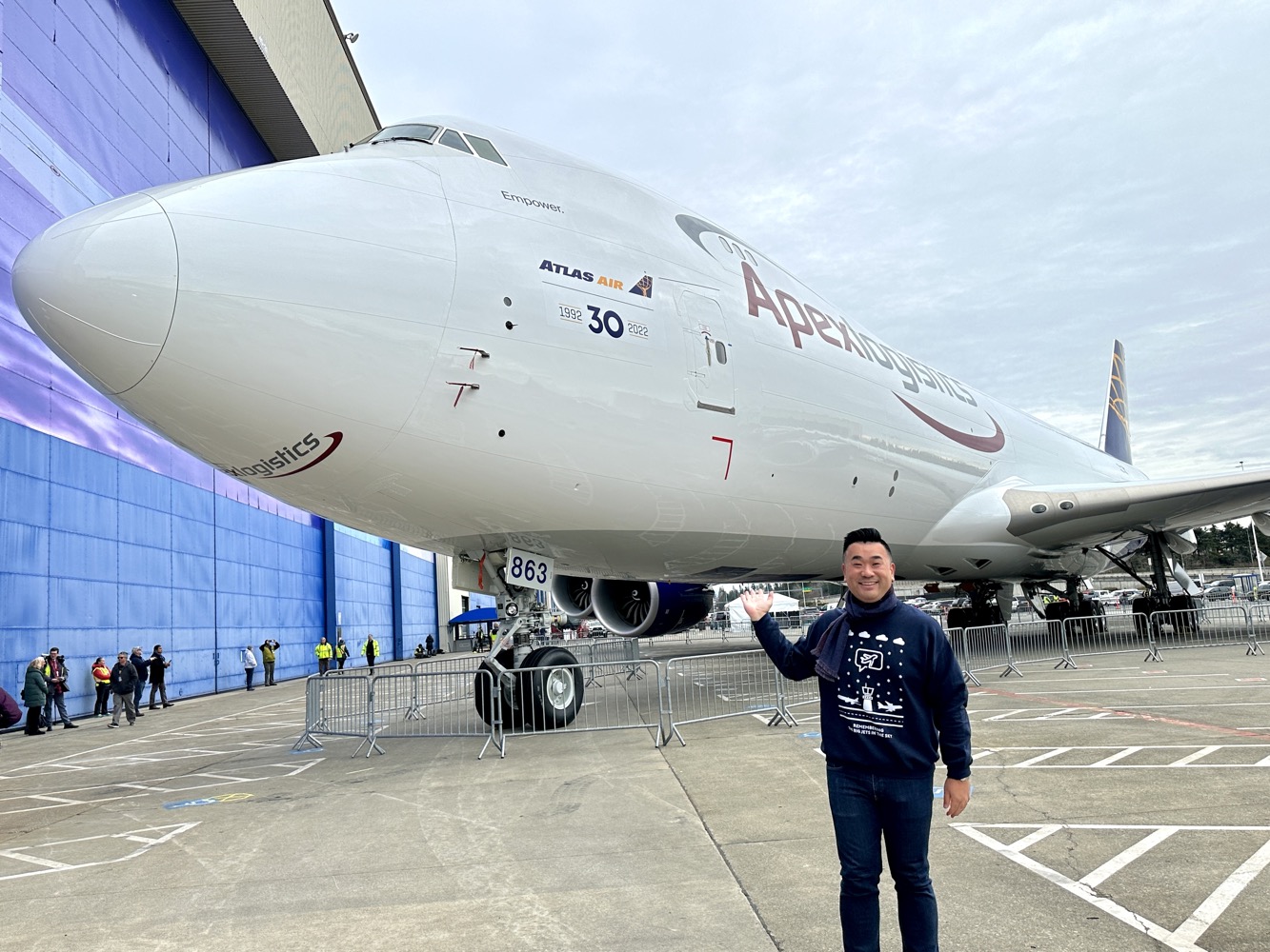 a man standing in front of a large airplane