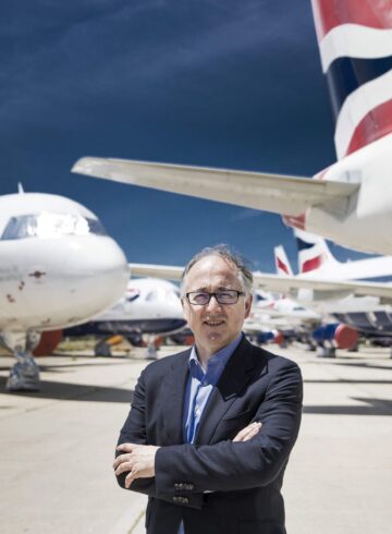 a man standing in front of airplanes