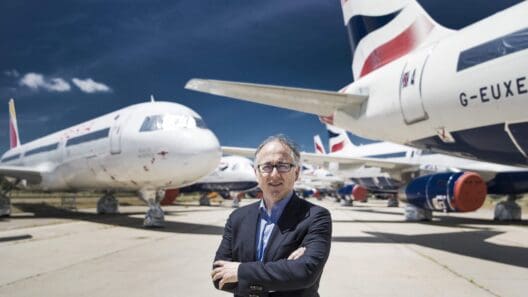 a man standing in front of airplanes