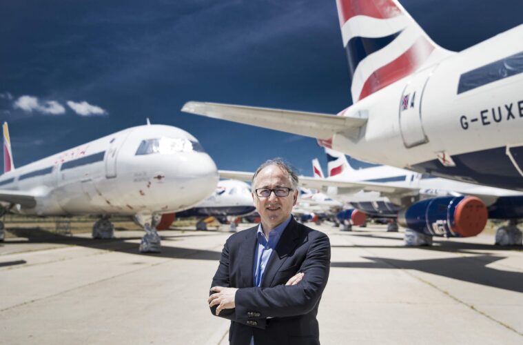 a man standing in front of airplanes