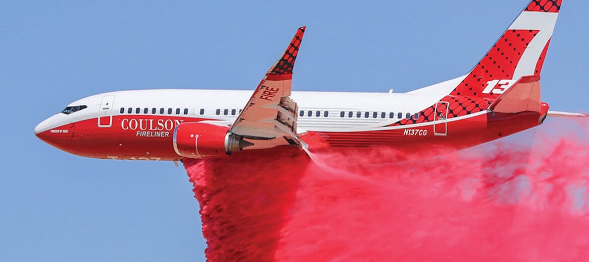 a plane with a red cloud of smoke