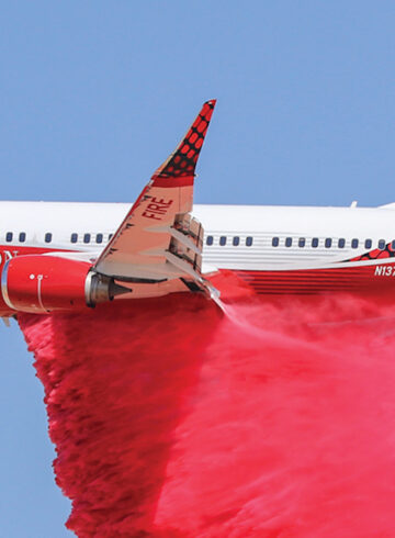 a plane with a red cloud of smoke