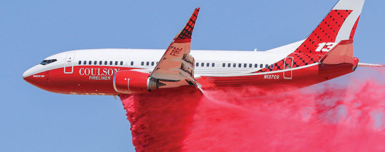 a plane with a red cloud of smoke