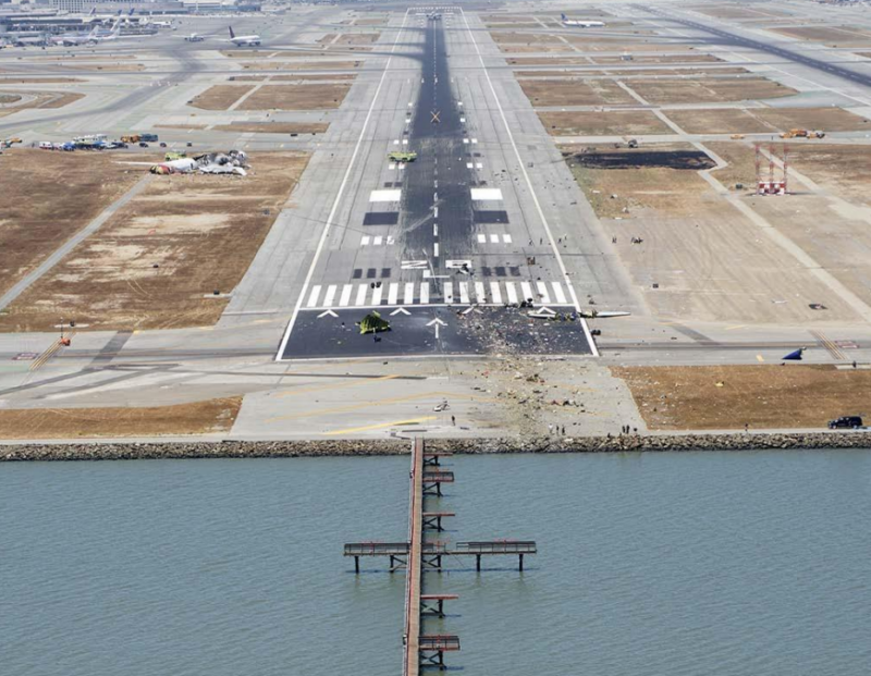 an airport runway with a dock and planes