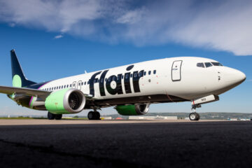 a white airplane on a runway