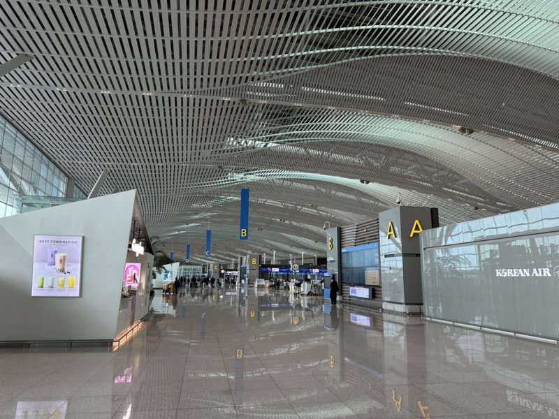 a large airport with people walking in the middle