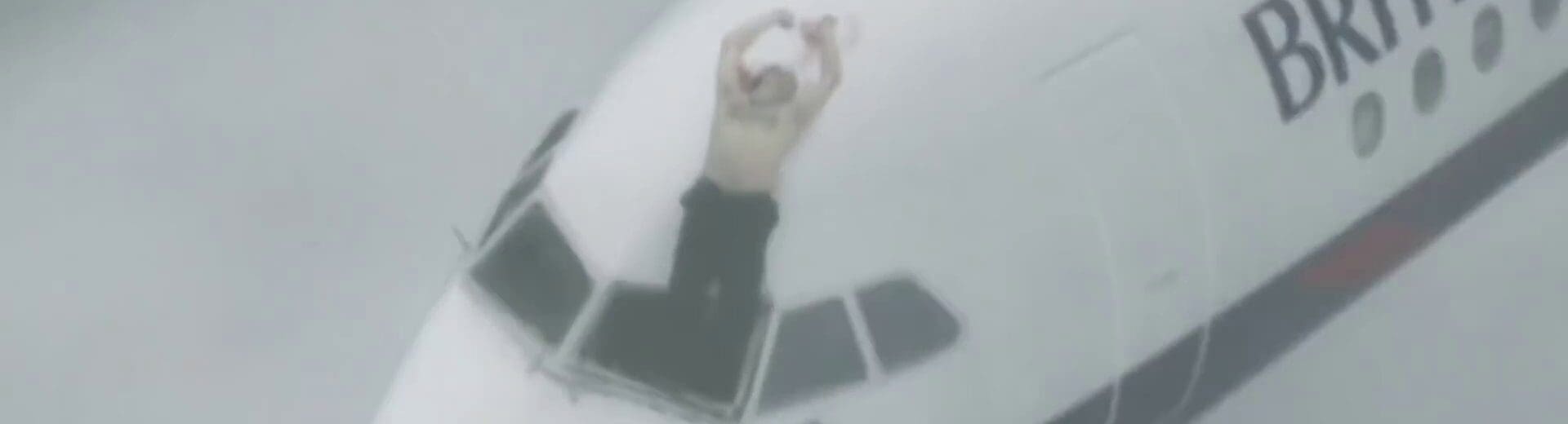 a man standing on the cockpit of an airplane