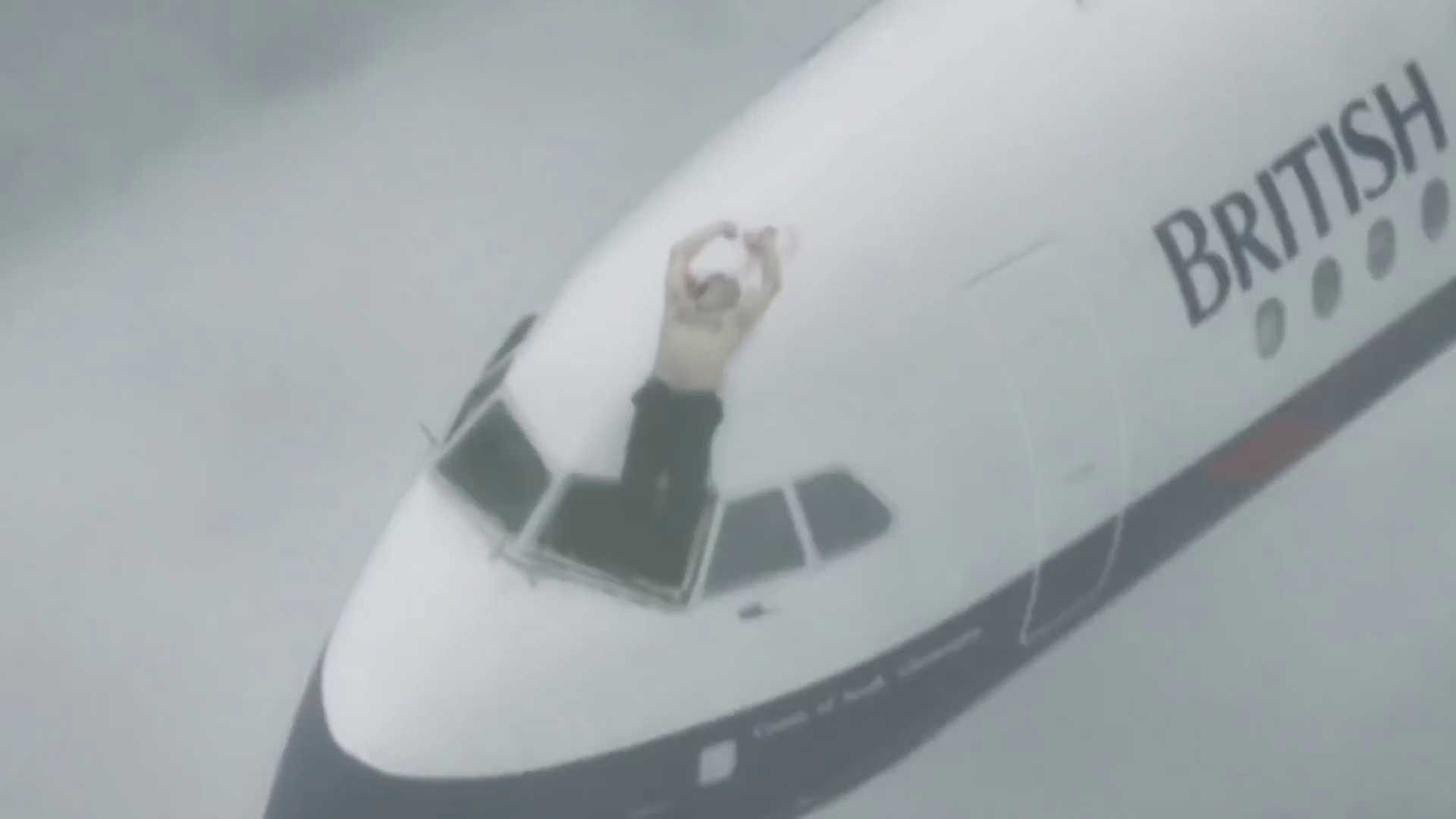 a man standing on the cockpit of an airplane