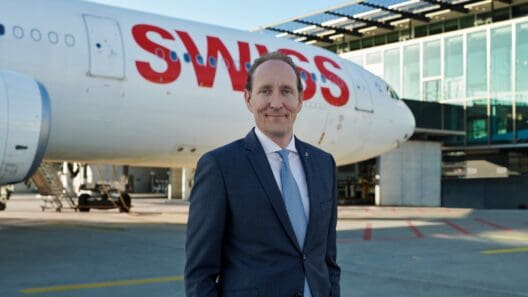 a man in a suit standing in front of a plane