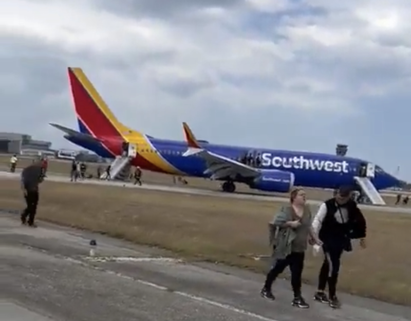 people walking past an airplane