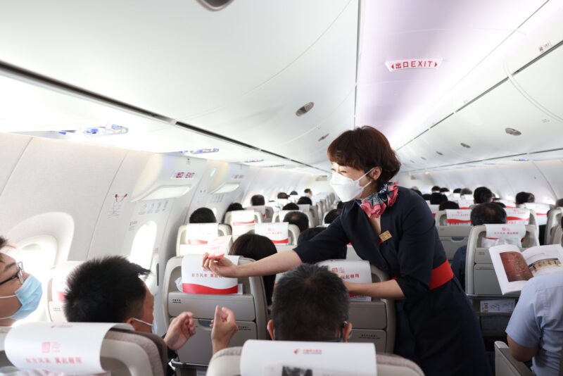 a woman wearing a mask on an airplane