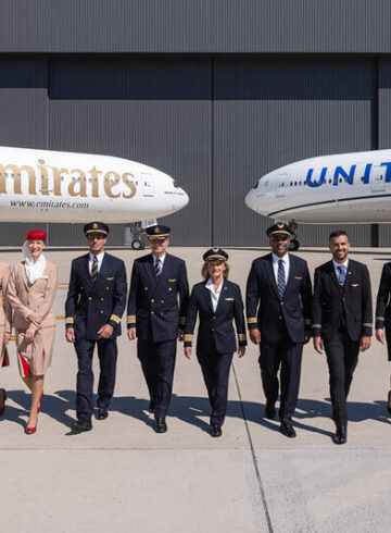 a group of people in uniform standing in front of airplanes