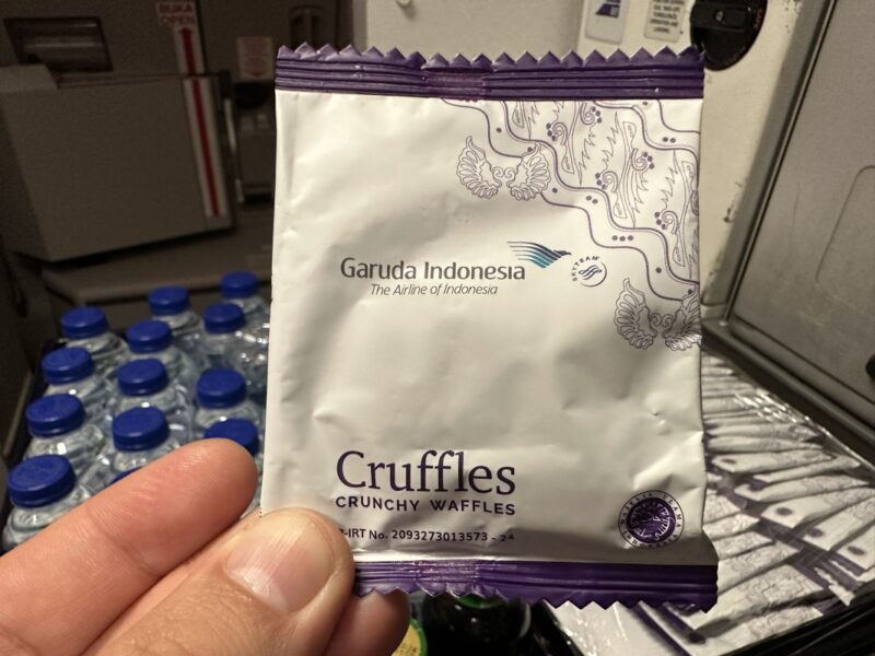 a hand holding a small package of cruffles
