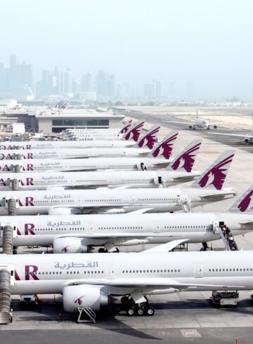 a group of airplanes parked on a runway