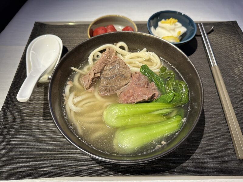 a bowl of soup with meat and vegetables