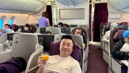 a man sitting in a chair with a drink in his hand