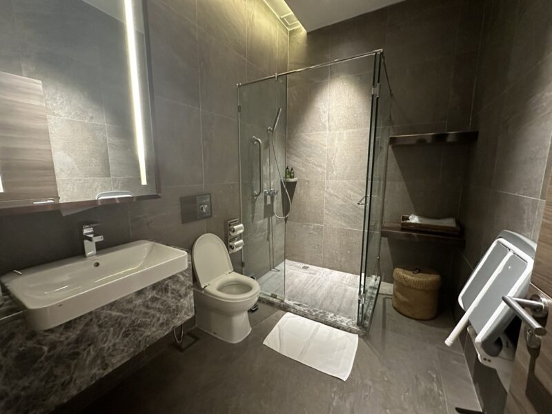 a bathroom with a glass shower and sink