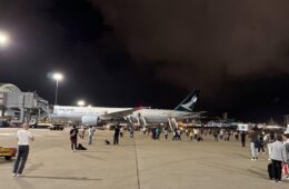 a large airplane on the tarmac at night