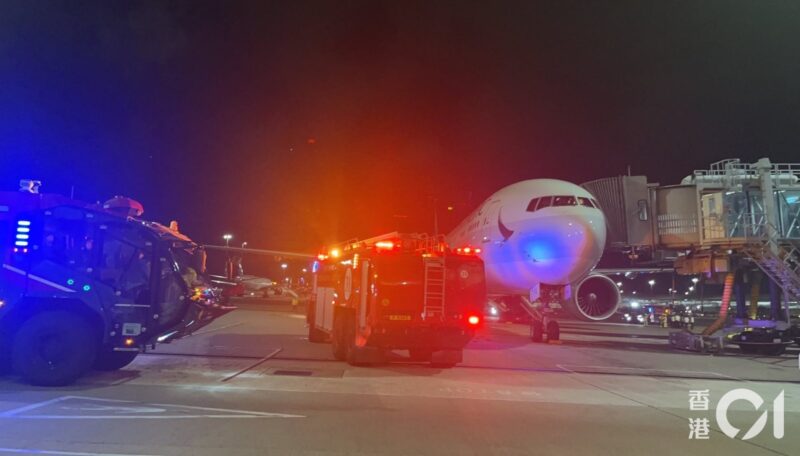 a firetruck and a plane at night