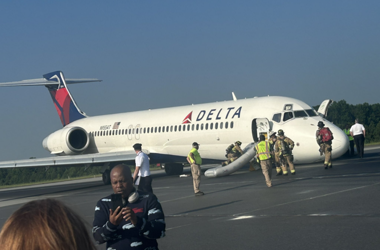 a group of people standing next to an airplane