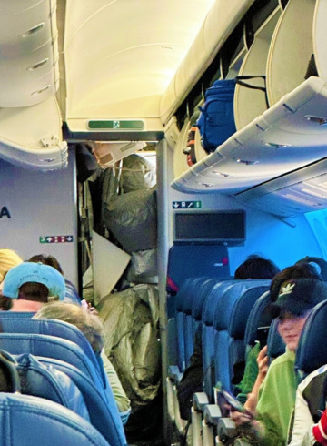 a group of people sitting in an airplane