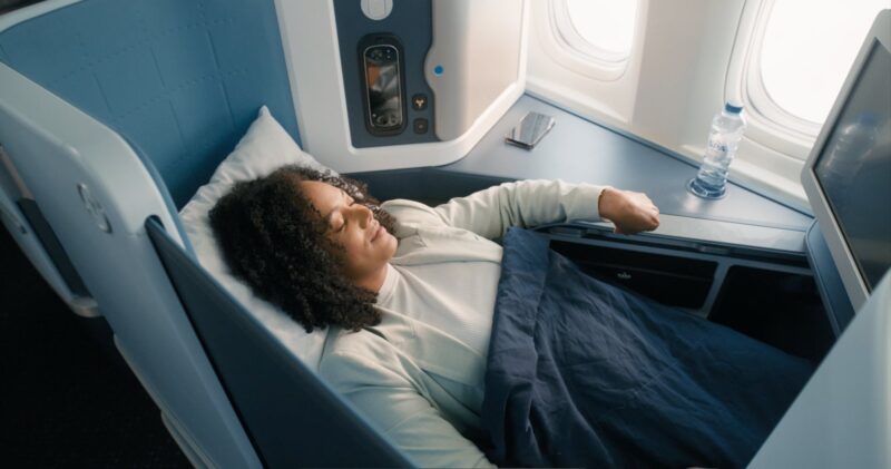 a woman sleeping in a plane