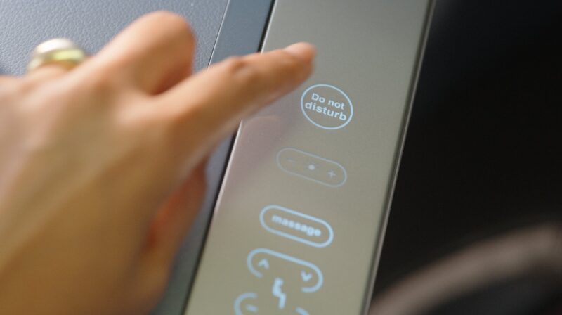 a finger pressing a touch screen