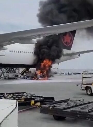 a plane on fire with smoke coming out of the wing