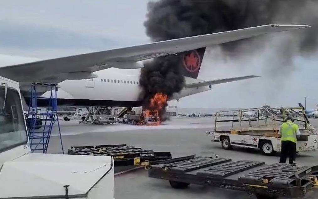 a plane on fire with smoke coming out of the wing