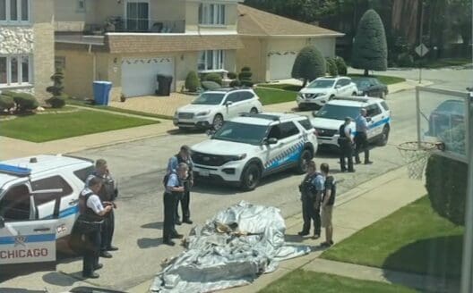 a group of police officers standing in front of a body of a body