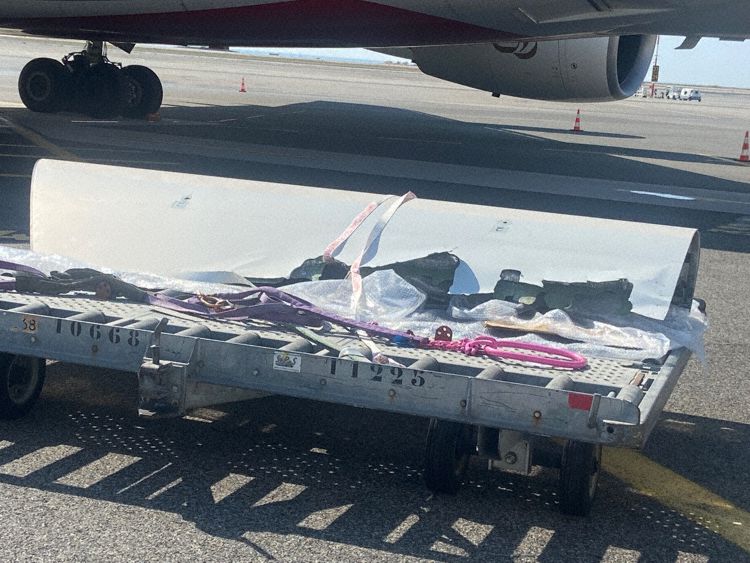 a plane with a broken luggage carrier