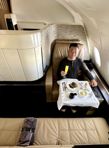 a man sitting in a chair with food on it