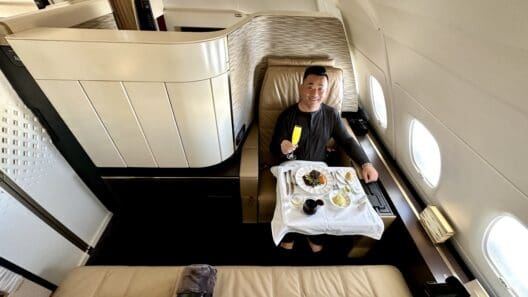 a man sitting in a chair with food on it