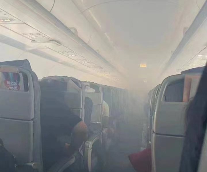 a group of people sitting in an airplane