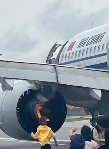 a group of people standing around an airplane