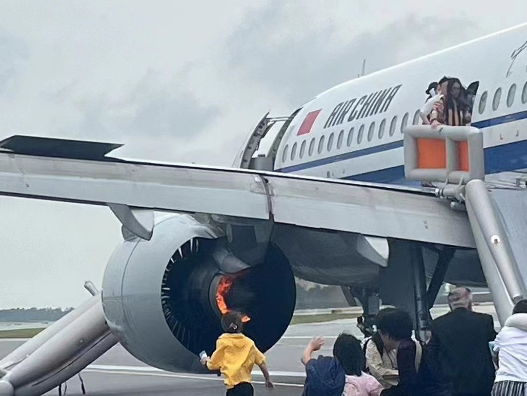 a group of people standing around an airplane