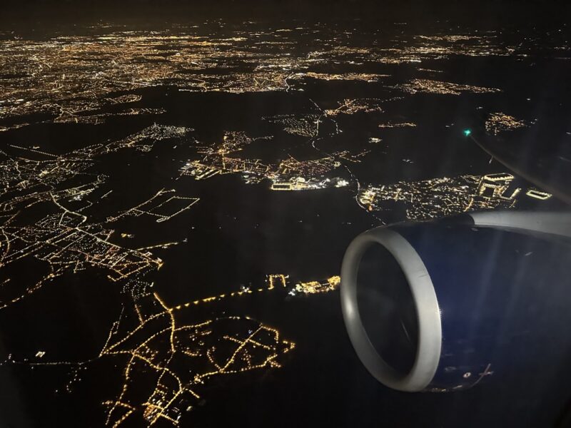 an airplane wing and a city at night