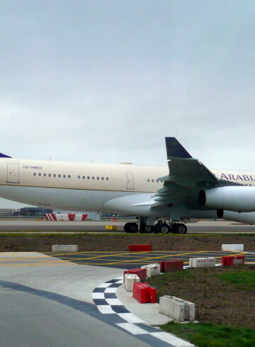 a large white and blue airplane on a runway