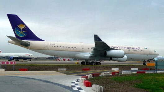 a large white and blue airplane on a runway