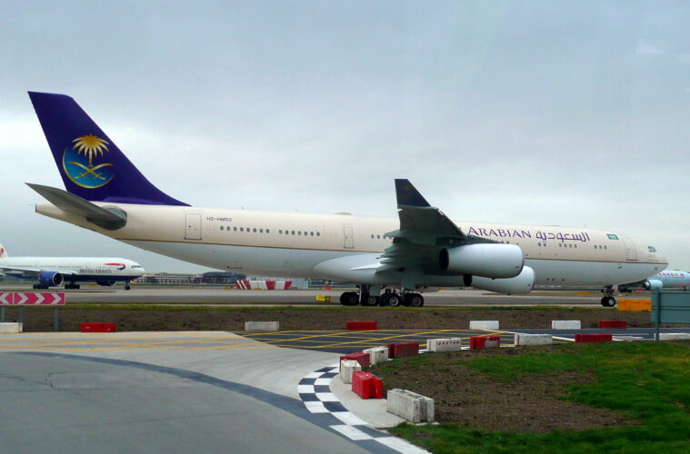 a large white and blue airplane on a runway