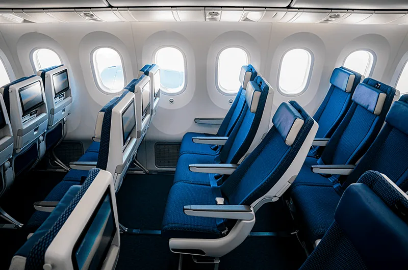 a row of blue seats in an airplane