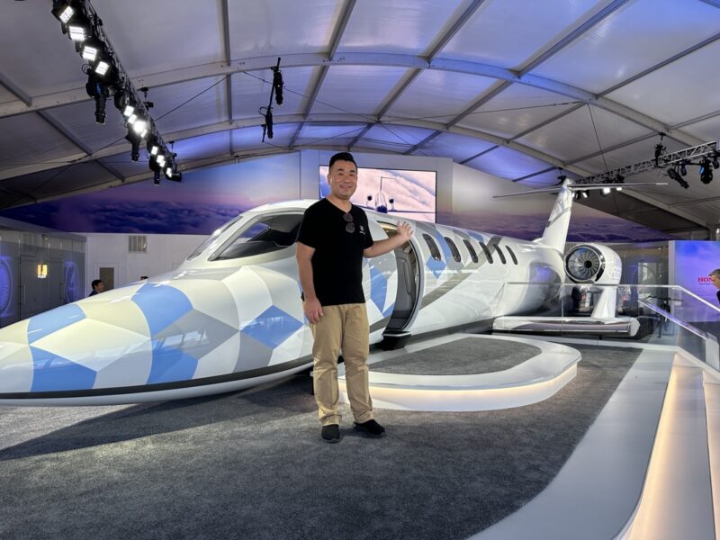 a man standing next to a plane